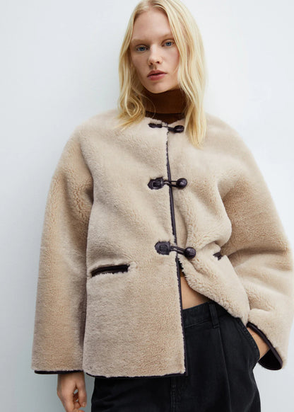 Faux fur coat with applications
